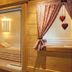Landhotel Christopherhof in Grafenwiesen: wooden sauna room with glass door and heart decorations