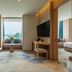 Expo Garden Resort Hotel Jinan guest room with window seat, city view, and connecting bedroom