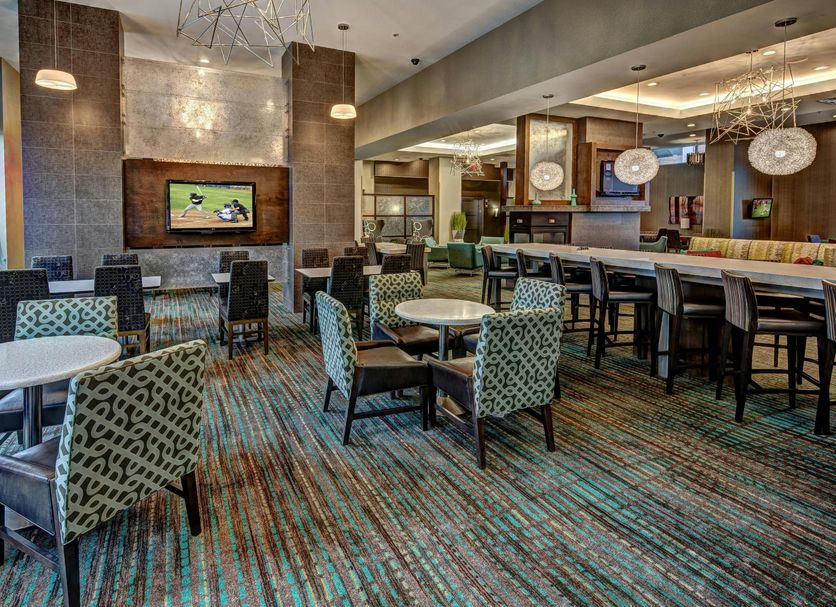 Residence Inn by Marriott Norfolk Downtown lobby lounge with bar, tables and chairs in Norfolk