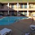 Motel 6 Little Rock, Ar - Airport outdoor pool in a courtyard with guest rooms and lounge chairs