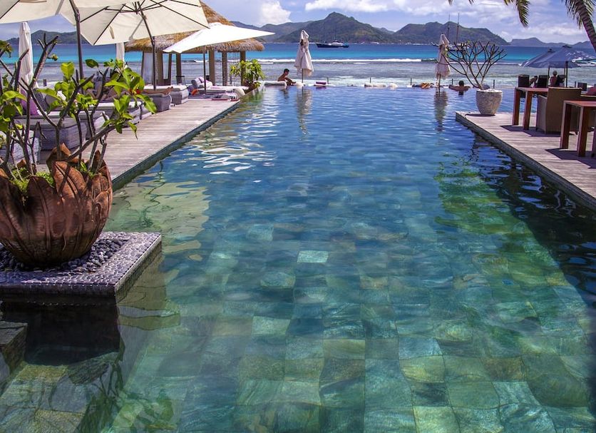 Le Domaine de L'Orangeraie Resort and Spa in La Digue Island features a long infinity pool with ocean views.
