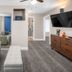 The Inn at Boatworks, Lake Tahoe in Tahoe City: modern suite with sofa, TV, and mirror closet