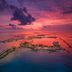 Hard Rock Hotel Maldives in Malé with overwater villas and lagoon islands at sunset