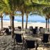 Hotel Marbella Playa Larga in Ixtapa: shaded beachfront lounge chairs and tables overlooking the ocean