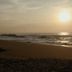 The Beach Camp Yala in Kirinda, beachfront sunset with ocean waves and two people on the sand