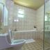 Kilimo Grand Resort Nairobi bathroom with bathtub, toilet, shower and glass partition