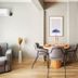 Taks-Inn Suites Istanbul room with dining table, sofa, wall-mounted TV and Netflix screen
