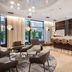 NH Monterrey La Fe in Monterrey lounge with bar seating, modern chairs, and large windows