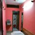 Yes Please Guest House, New Delhi: simple single room with twin beds, pink walls and an attached bath doorway