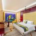 Shijiazhuang Shen Zhou 7 Star Hotel room with king bed, colorful wall art, and seating area