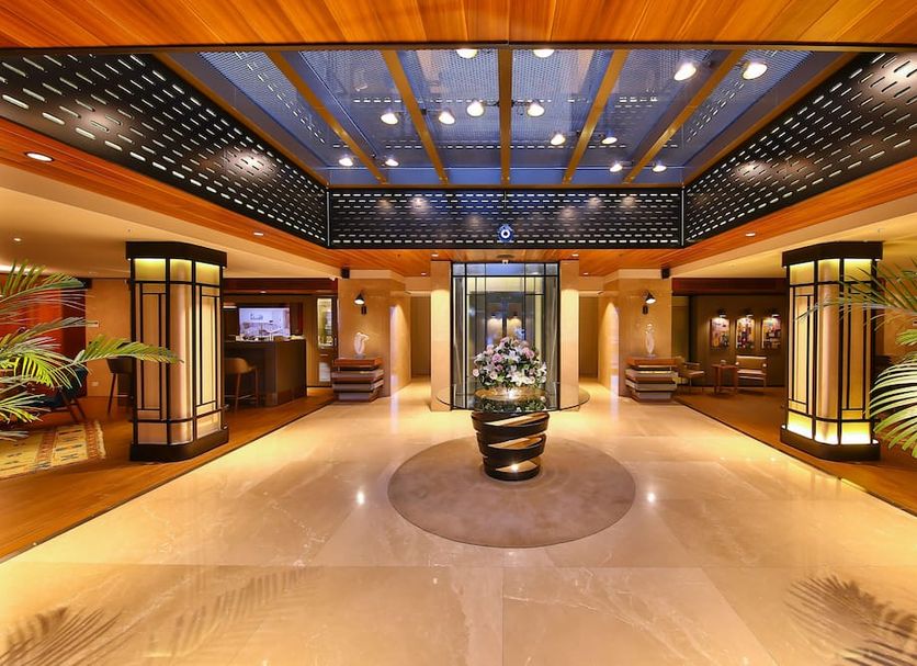 Tzl Suites Istanbul lobby with central floral display, polished floor, and warm illuminated seating areas