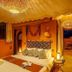 Ksar Ighnda in Aït Ben Haddou, cozy tent-style bedroom with canopy bed and warm lantern lighting
