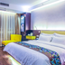 Shell House Hotel in Baoding guest room with king bed, yellow chair, table, and sheer curtains