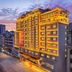 Vienna Hotel Sanya Bay No.1 in Sanya at dusk, exterior lit with city street view