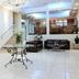 C Hotel Tiberias lobby with reception desk, chandelier, seating area and glass-topped table