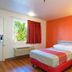 Motel 6 Twentynine Palms guest room with bed, desk, wall lights, and window air conditioner