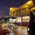 Countryman Motor Inn in Dubbo exterior at night with lit sign, patio seating and glowing entrance