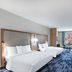 Fairfield by Marriott Inn & Suites Aberdeen, SD guest room with two beds, TV, and city-view window