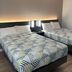 Studio 6 Vicksburg, MS room with two beds, patterned bedding and wall lighting