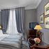 Le Dokhan's, Paris Arc de Tiromphe, a Tribute Portfolio Hotel room with canopy bed and striped walls in Paris