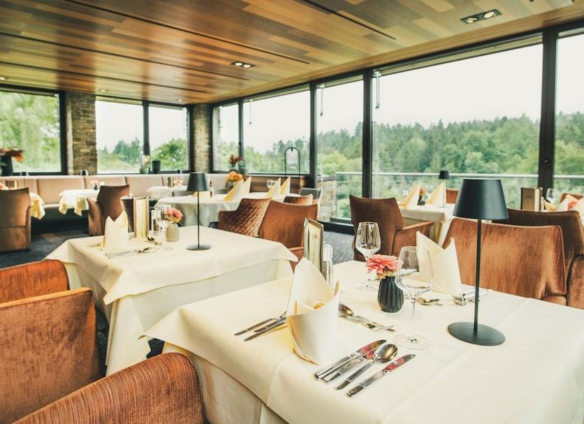 Gut Lauterbad Hotel in Freudenstadt dining room with large windows and forest views