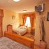 Ard na Breatha in Donegal guest room with twin beds, curtained windows and wall-mounted TV
