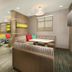 Residence Inn by Marriott Texarkana lounge with striped booths, colorful chairs and TV seating area