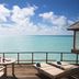 Anantara Dhigu Maldives Resort in Dhigufinolhu: oceanfront deck with loungers and table overlooking turquoise sea