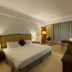 Oriental Crystal Hotel in Kajang guest room with king bed, desk, lamps and large window