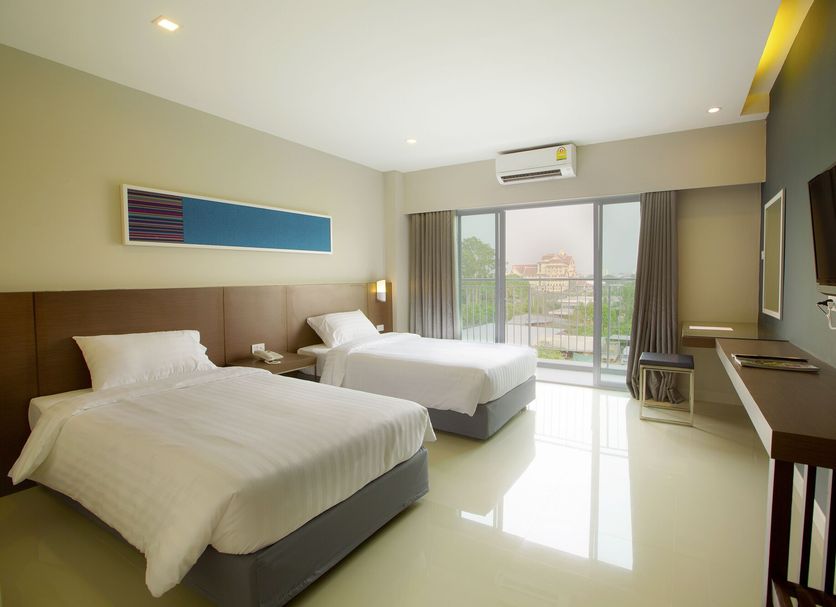 V Hotel Ubon Ratchathani guest room with twin beds, balcony view, and wall-mounted TV