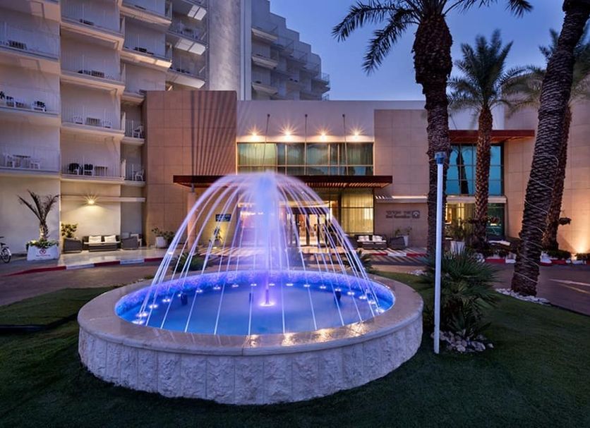 Herbert Samuel Hod Dead Sea Hotel in Ein Bokek with illuminated fountain and palm-lined entrance