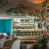 W Algarve in Albufeira: stylish bar lounge with sculptural ceiling, turquoise accents and stools