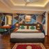 Hotel Jagjeet, Darjeeling: modern double room with geometric accent wall, desk, and wood flooring