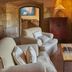 Hacienda Zorita Wine Hotel & Spa in Valverdón: cozy stone lounge with armchairs, coffee table and green shutters