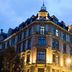 Hotel Victoria in Frankfurt am Main at dusk, featuring a historic corner facade with lit windows
