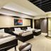 Hotel The Capital, Dhaka guest room with three beds, desk, mirror, and wall-mounted TV