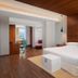 Aloft Bengaluru Outer Ring Road guest room with king bed, wood ceiling, desk and city view