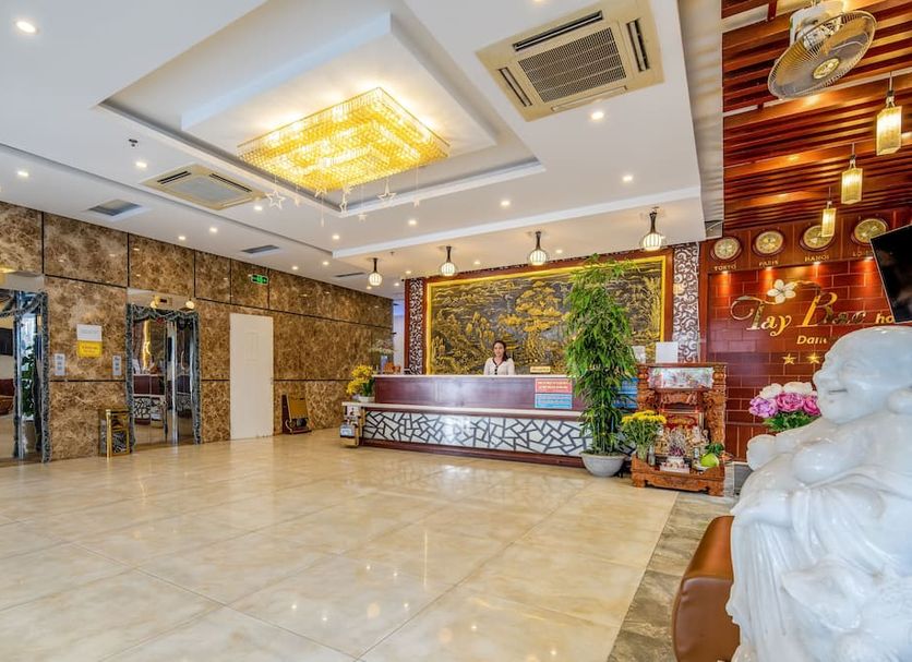 Tay Bac Hotel Da Nang lobby with reception desk, polished tile floor and ornate ceiling lighting