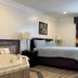Home Suites Thief River Falls guest room with bed, jacuzzi tub, and bedside lamps