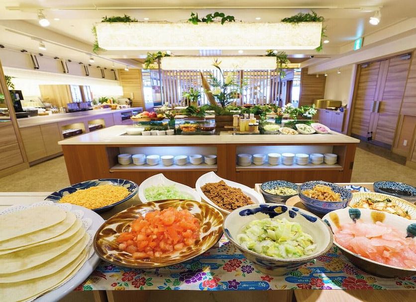 Vessel Hotel Campana Okinawa in Chatan buffet spread with salads, shrimp, and plates in a bright dining room
