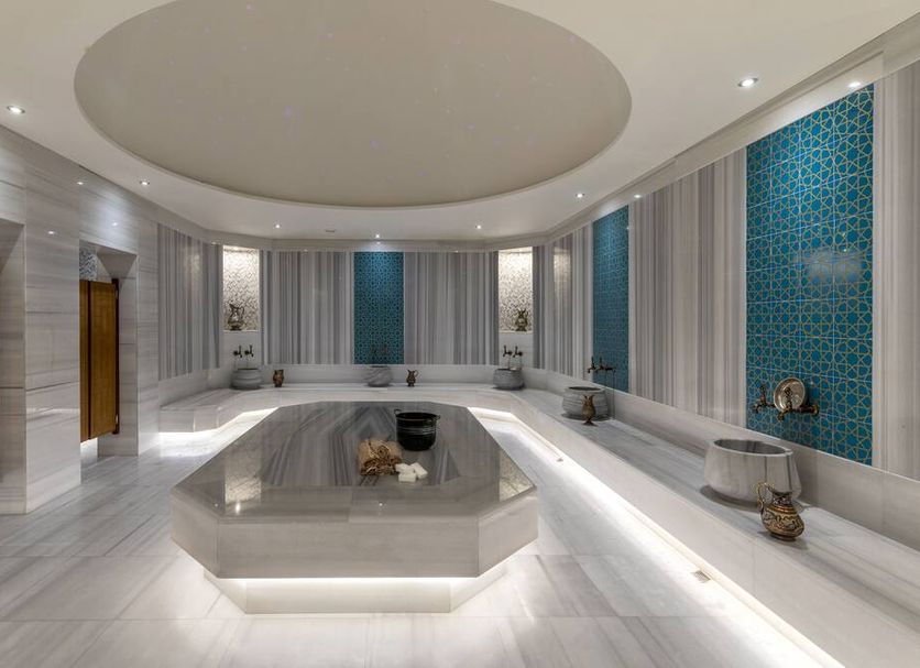Radisson Blu Hotel Trabzon spa with white seating, illuminated hexagonal table and blue mosaic wall