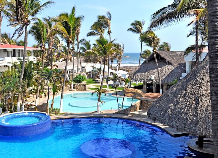 Mar Paraiso Queen in Acapulco with ocean view, palm trees, and multiple outdoor pools