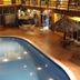 Gran Hotel Paris in La Ceiba indoor courtyard pool with lounge chairs and thatched umbrellas
