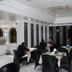 White Fort Hotel Dubai restaurant with black chairs, white tablecloths and diners indoors