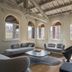 Lords of Verona Luxury Apartments in Verona, airy lounge with arched windows and modern gray seating