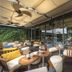 Hotel G Yangon outdoor terrace seating beside glass-walled bar with canopy in Yangon