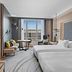Hilton Munich Airport room with twin beds, city view window, seating area in Munich