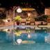 Les Villas Ottalia Yoga & Diving, Gili Meno pool at night with lounge chairs and cabanas
