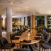 Hennessy Park Hotel in Ebene restaurant with long dining table and curved bar seating