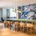 Hennessy Park Hotel in Ebene meeting space with long table, bar stools, and abstract wall art